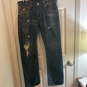 True Religion Jeans with distressing and orange stitching.
